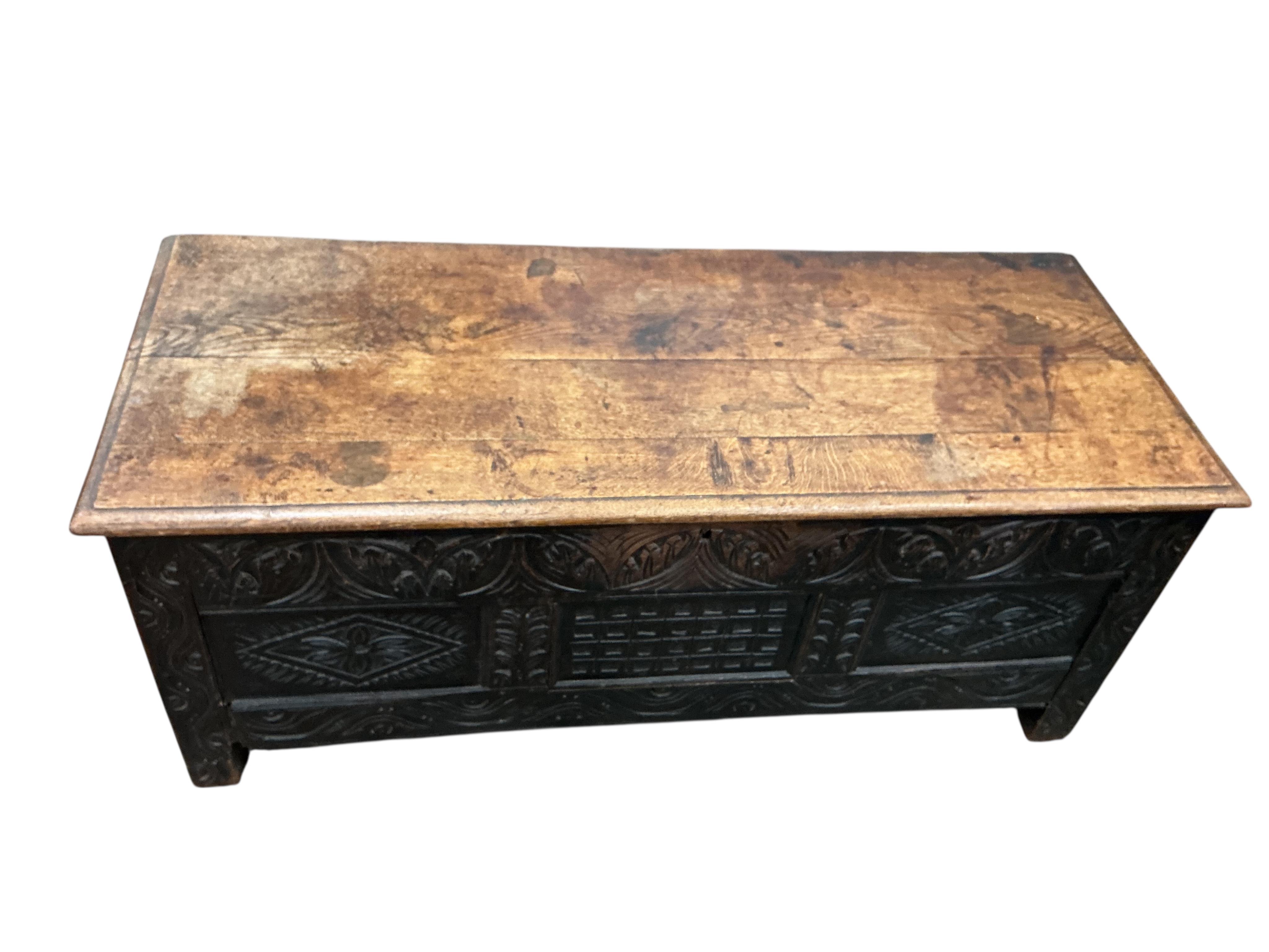 An 18th century panelled oak coffer, width 136cm, depth 54cm, height 56cm
